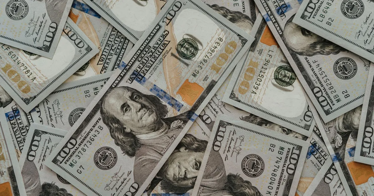 Dólar e juros sobem: notas de US$ 100 ilustram alta do petróleo.